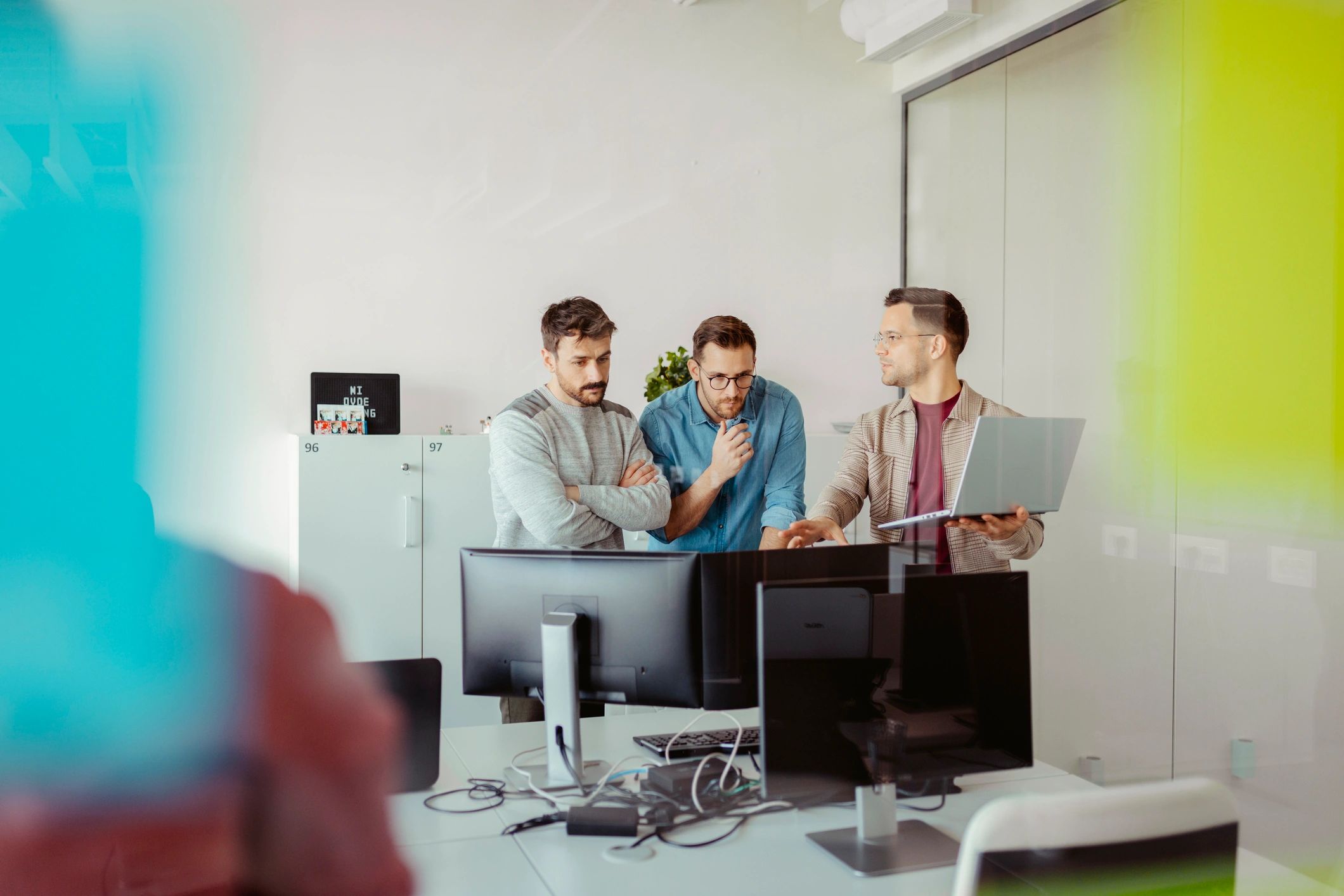 IT professionals collaborating in an office while working on computers