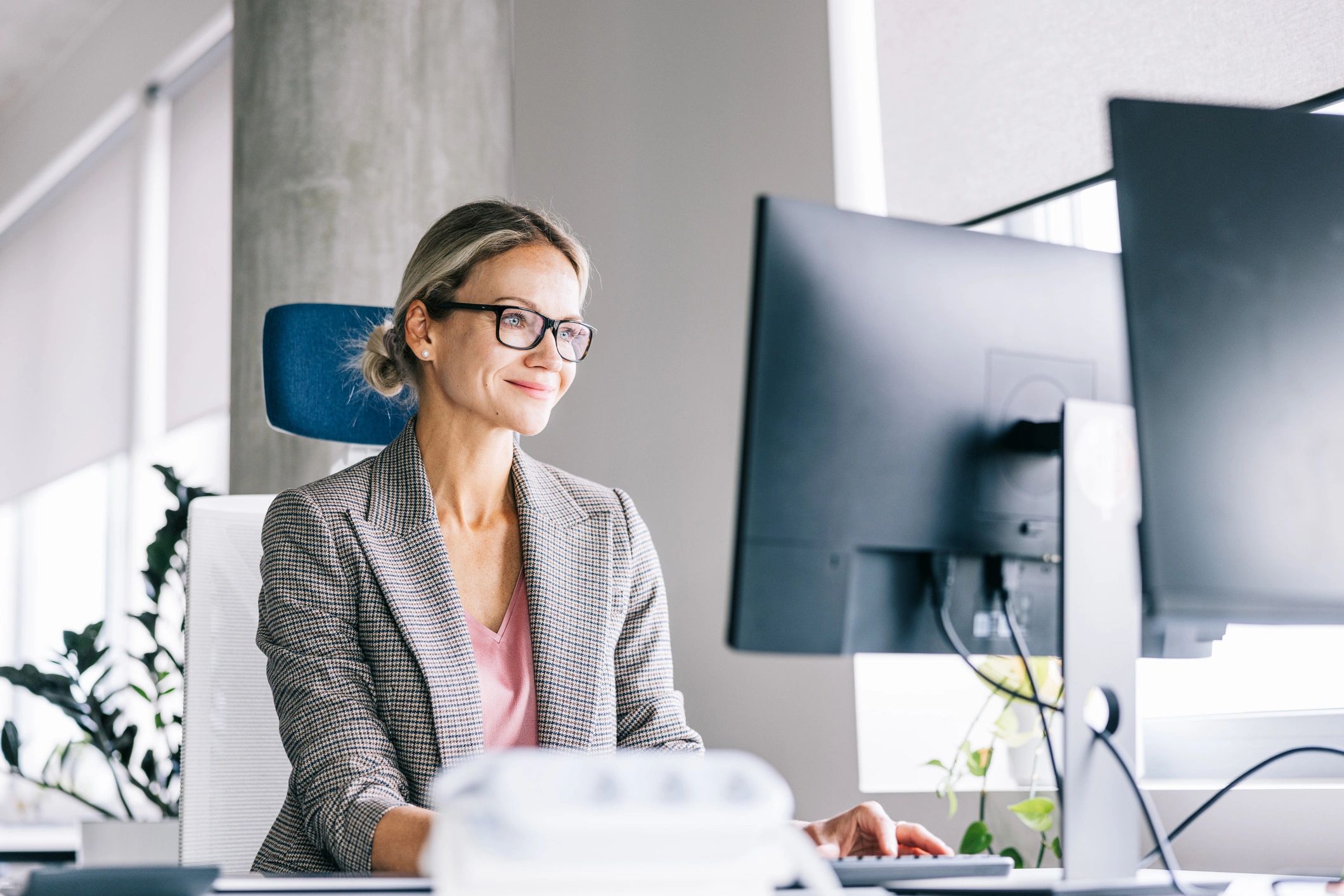 Professional headshot of a businesswoman at her desk